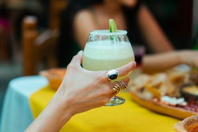 a person holding a margarita