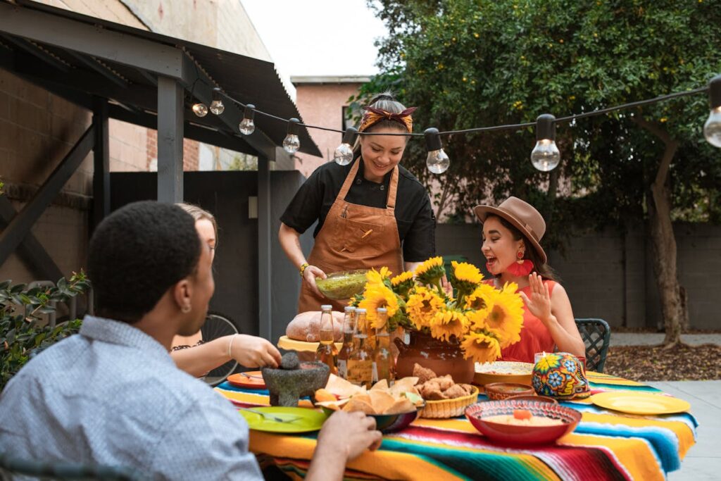 Group of friends enjoying Mexican food at a vibrant Cinco de Mayo fiesta with Rancho La Gloria.